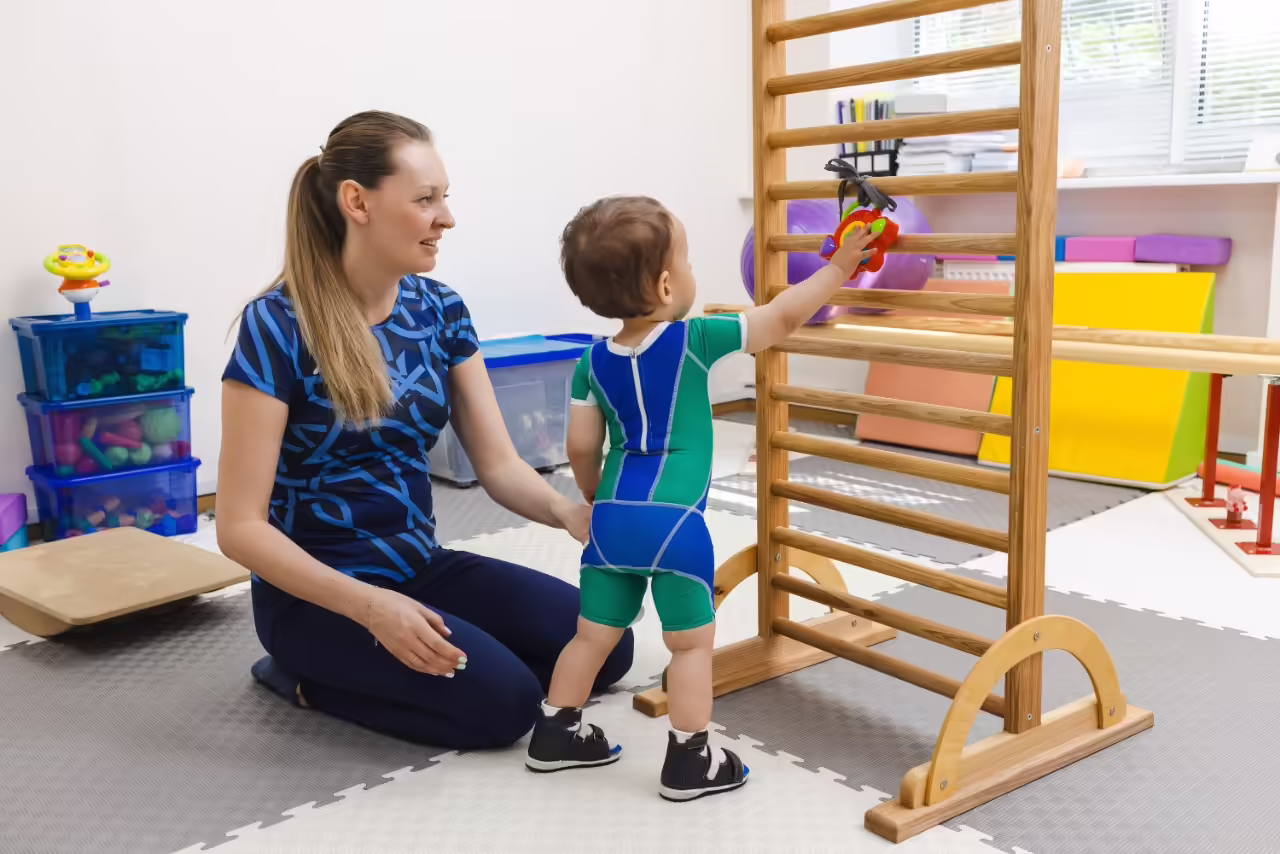 adult helping toddler with physical therapy exerci 2026 03 25 04 44 30 utc