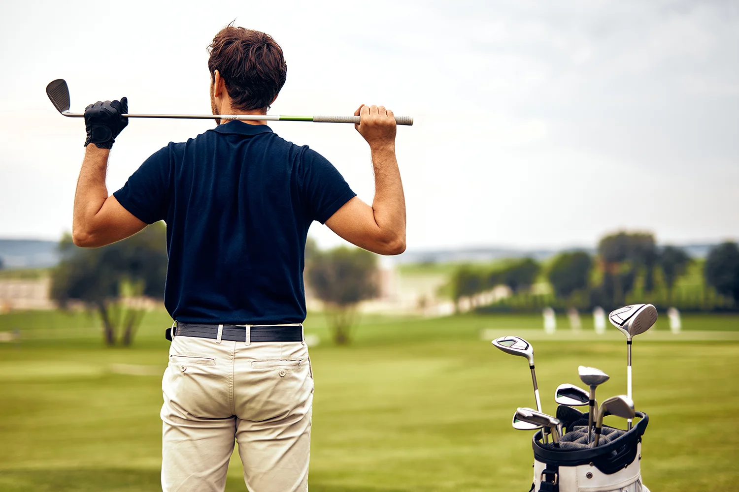 a golfer preparing intently for a precise swing