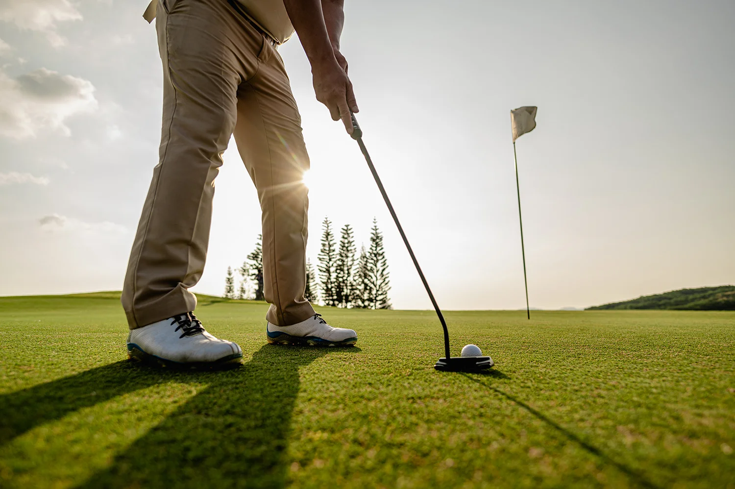 golfer man aiming at golf ball in a ready position
