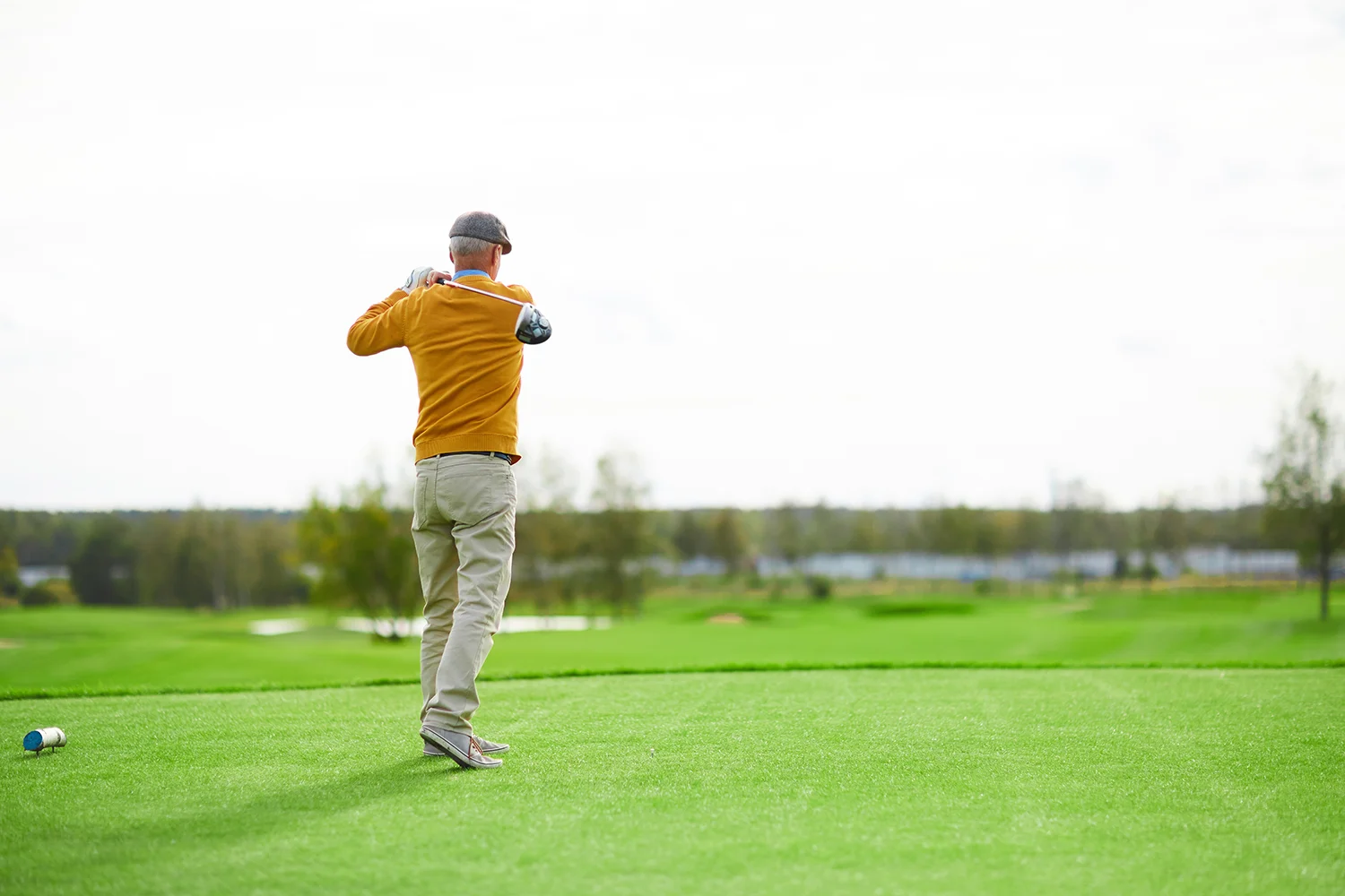 man golfing on a green golf course