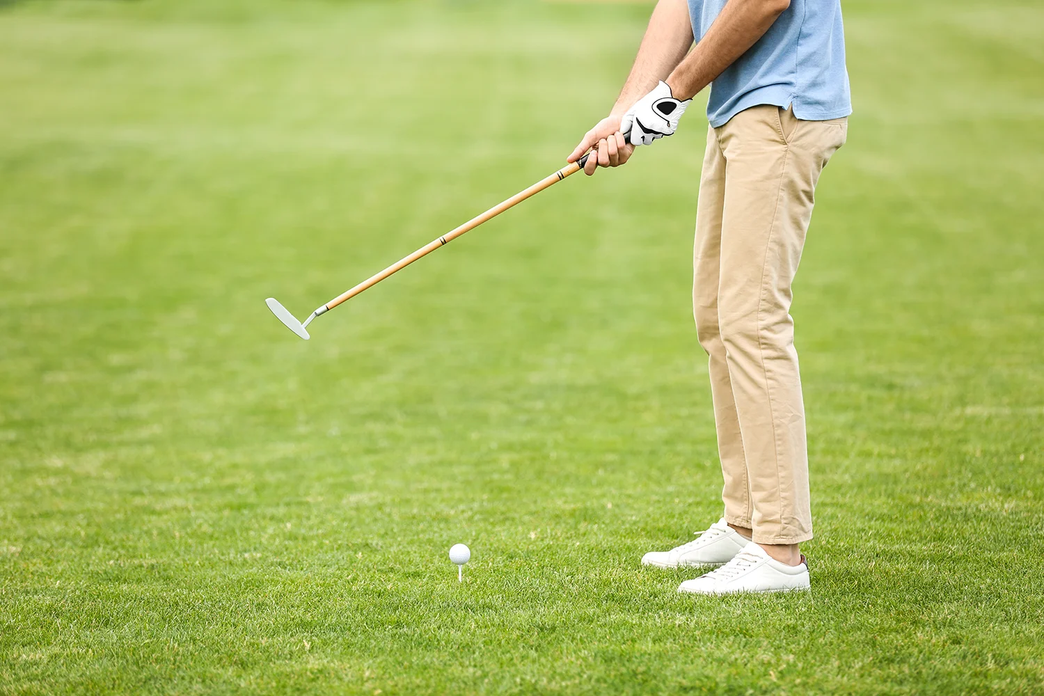 man playing golf on green course sport