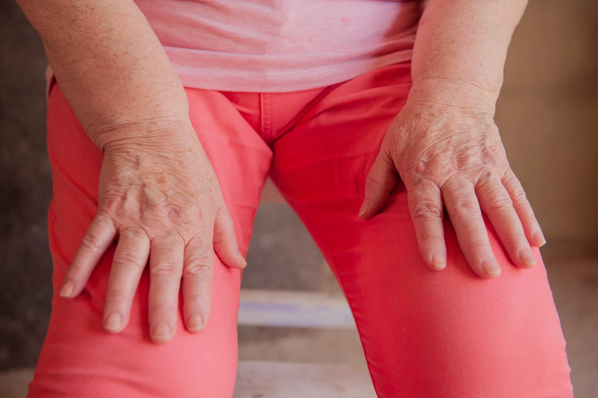 senior woman with hands resting on knees