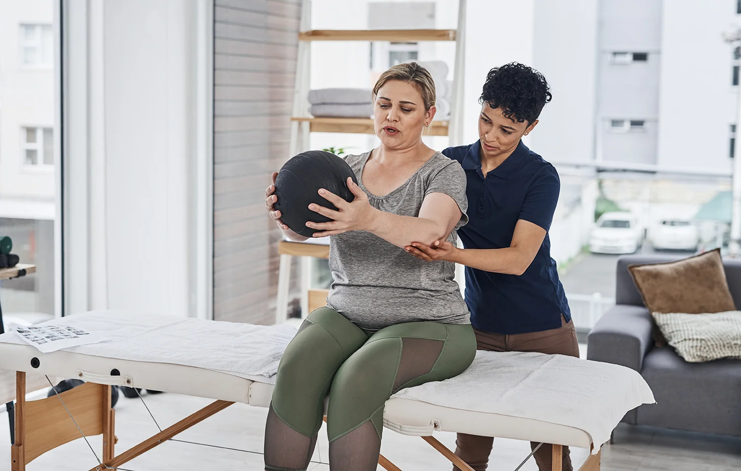 woman exercises with therapist in physical therapy