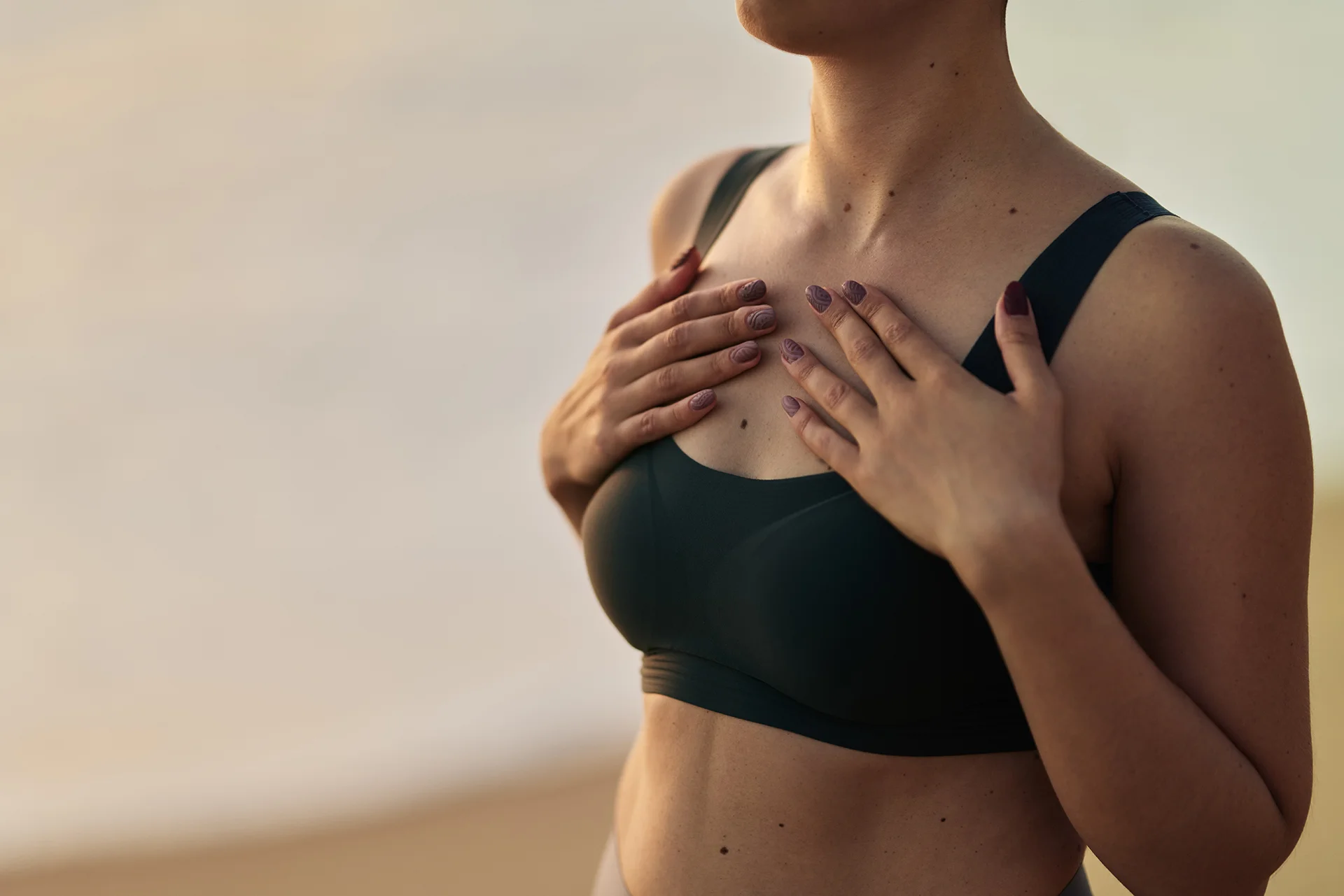 woman in sports bra posing on beach