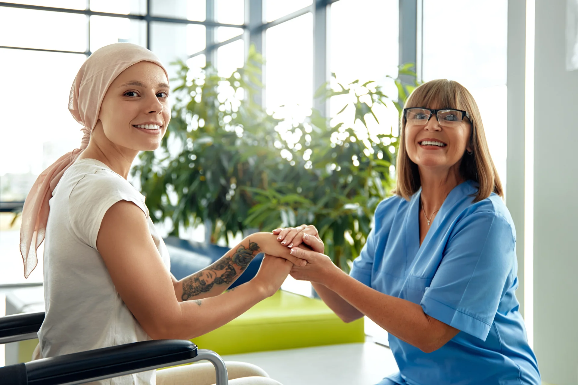 smiling patient and caregiver holding hands